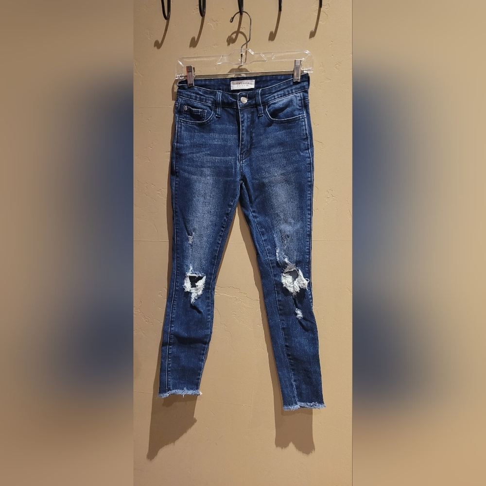 Dark blue, denim jeans, with rips.